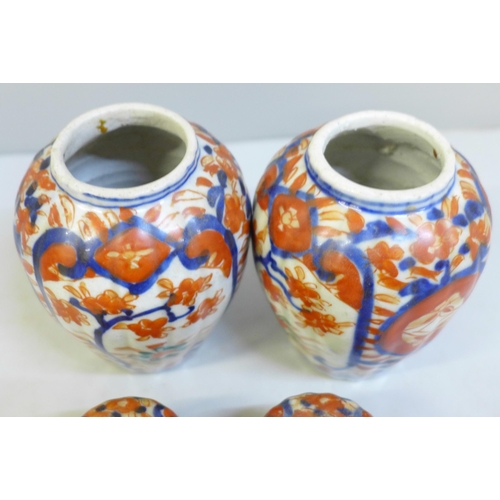 620 - A pair of Japanese Kutani bottle vases and a pair of Imari lidded vases, a/f