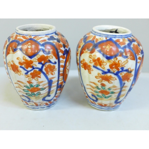 620 - A pair of Japanese Kutani bottle vases and a pair of Imari lidded vases, a/f