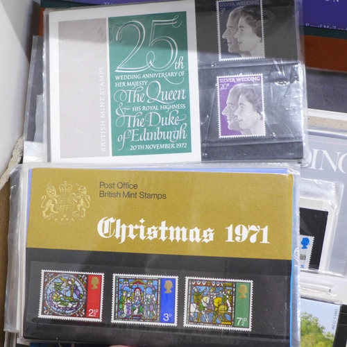 655 - Stamps; a box of GB presentation packs, year packs, 1987 year book, Channel Tunnel pack, etc.