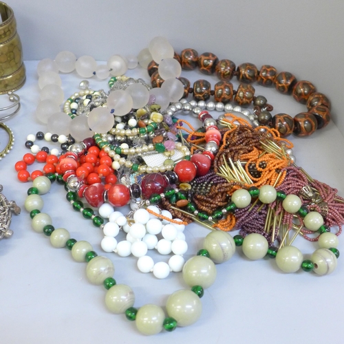 660 - Three bags of costume jewellery, necklaces and bangles