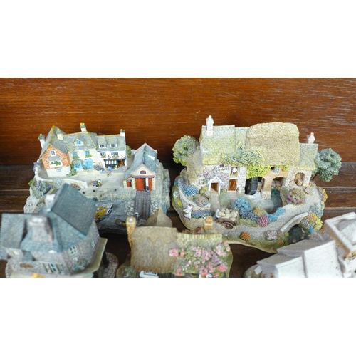 689 - A collection of thirteen Lilliput Lane houses including two RNLI stations