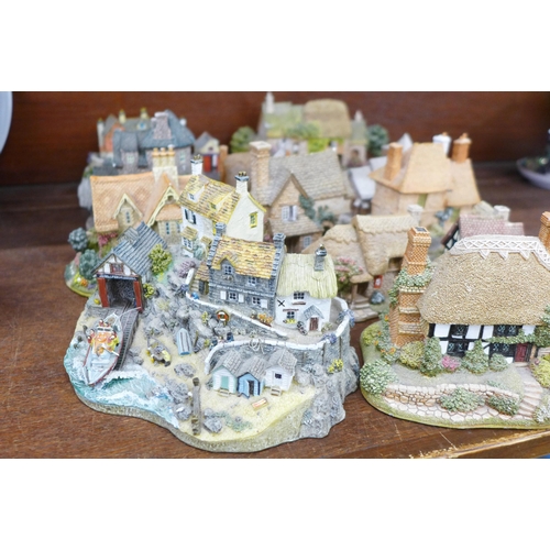 689 - A collection of thirteen Lilliput Lane houses including two RNLI stations