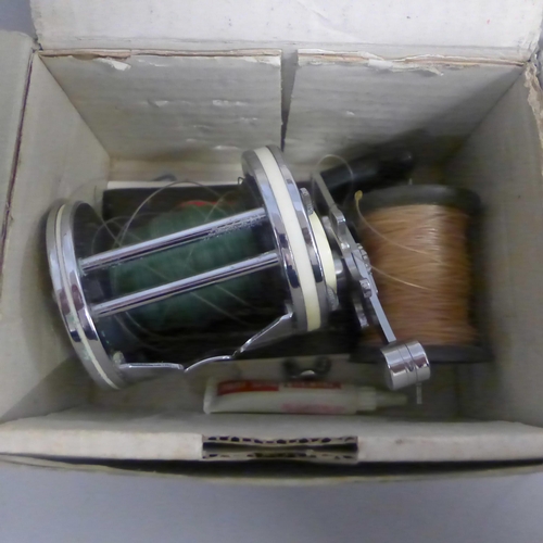 743 - Two fishing reels; Mitchell Garcia 6001A and one other Bakelite and metal marked 'Made in Australia'