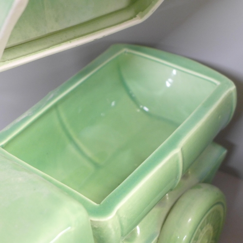 755 - A pair of mid 20th Century green ceramic water trucks/tankers, 33cm