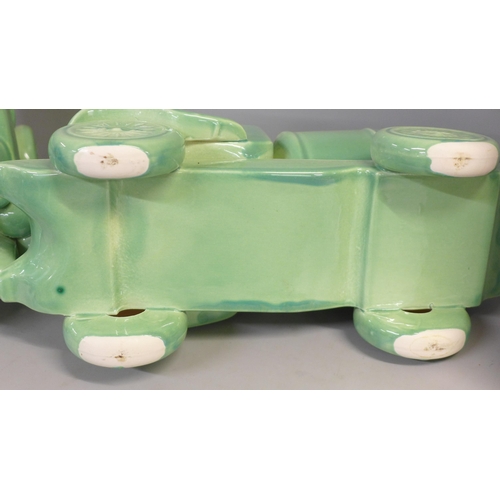 755 - A pair of mid 20th Century green ceramic water trucks/tankers, 33cm