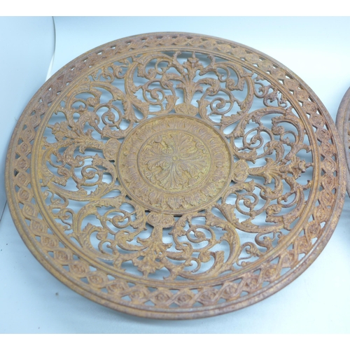 796 - Two 19th Century cast iron wall plaques, both 23cm, one with hairline crack on the rim