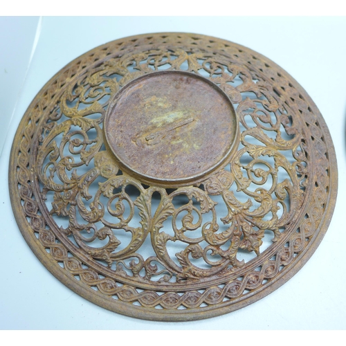 796 - Two 19th Century cast iron wall plaques, both 23cm, one with hairline crack on the rim