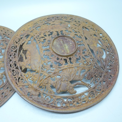 796 - Two 19th Century cast iron wall plaques, both 23cm, one with hairline crack on the rim