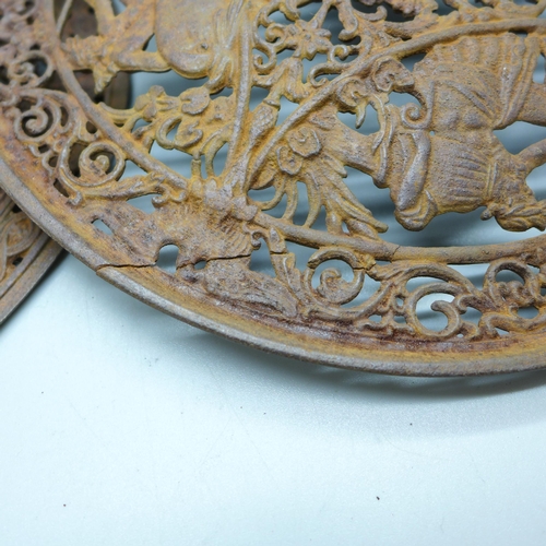 796 - Two 19th Century cast iron wall plaques, both 23cm, one with hairline crack on the rim