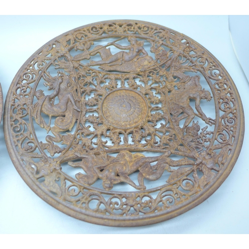 796 - Two 19th Century cast iron wall plaques, both 23cm, one with hairline crack on the rim