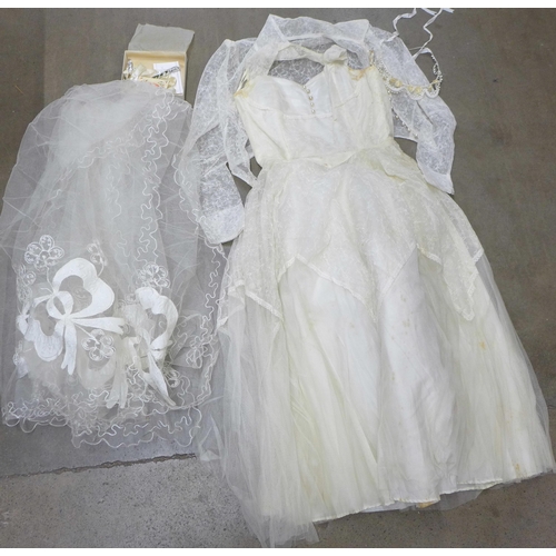 805 - A wedding dress from Thames Board Mills, Purfleet, in original box and packaging with veil, shawl, e... 