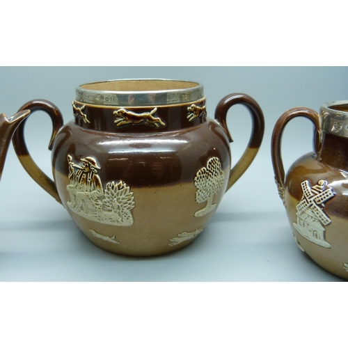 839 - A silver rimmed salt glaze tea service; teapot, sugar and cream