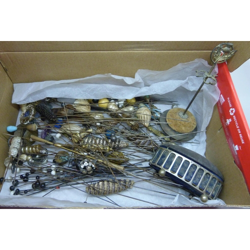 840 - A box of approximately 120 mixed hat pins including a few silver/white metal examples and two hat pi... 