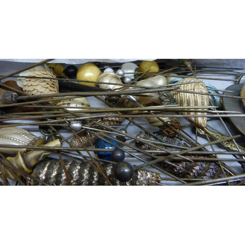 840 - A box of approximately 120 mixed hat pins including a few silver/white metal examples and two hat pi... 