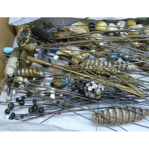 840 - A box of approximately 120 mixed hat pins including a few silver/white metal examples and two hat pi... 