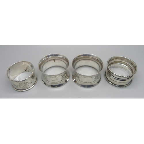 865 - A pair of silver napkin rings and two other silver napkin rings, 124g