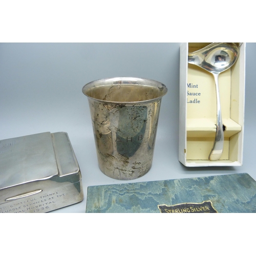 866 - A silver christening cup, London 1914, 125g, a silver mint sauce ladle, Sheffield 1939, 28g and a si... 