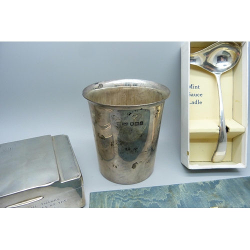 866 - A silver christening cup, London 1914, 125g, a silver mint sauce ladle, Sheffield 1939, 28g and a si... 