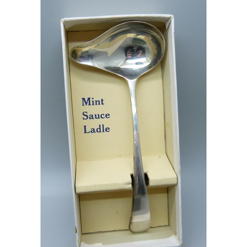 866 - A silver christening cup, London 1914, 125g, a silver mint sauce ladle, Sheffield 1939, 28g and a si... 