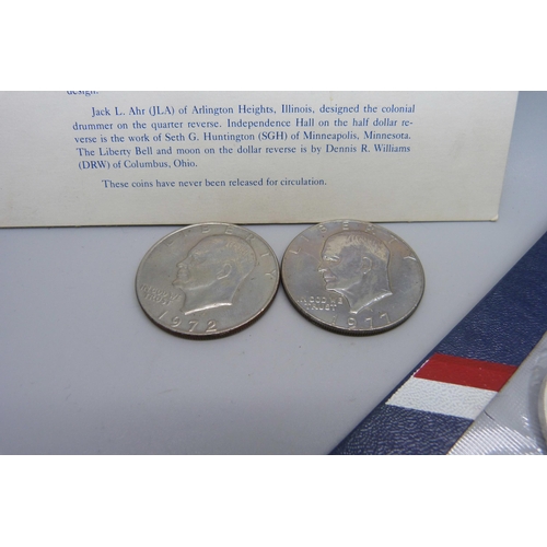 873 - Coins; a United States Bicentennial silver uncirculated set, two other dollars, 1972 and 1977