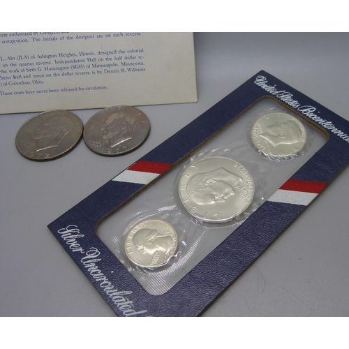 873 - Coins; a United States Bicentennial silver uncirculated set, two other dollars, 1972 and 1977