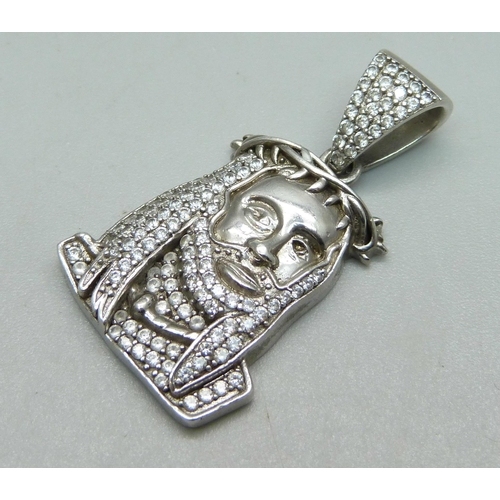 908 - A stone set pendant depicting Rastafarian, (tests as silver)