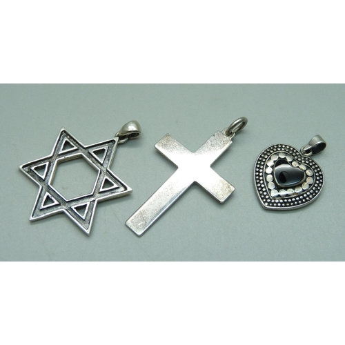 911 - A silver Star of David pendant, a silver heart pendant and a cross pendant