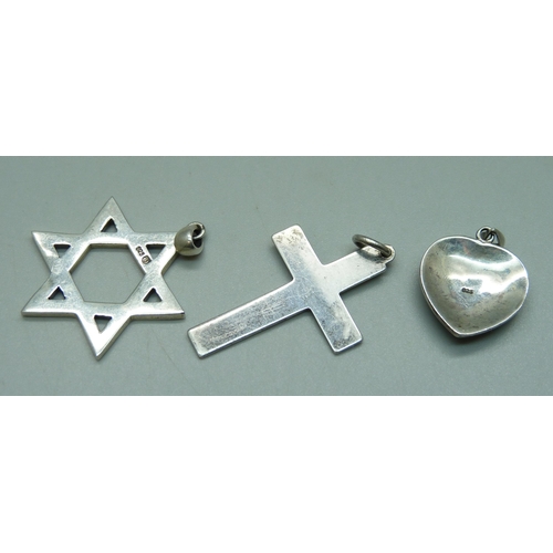 911 - A silver Star of David pendant, a silver heart pendant and a cross pendant