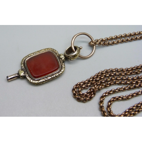 913 - A Victorian long guard chain and an antique watch key/fob