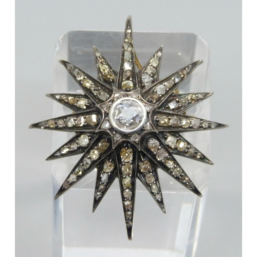 921 - A circa 1900 diamond set starburst pendant/brooch, centre stone approximately 0.75 carat diamond wei... 