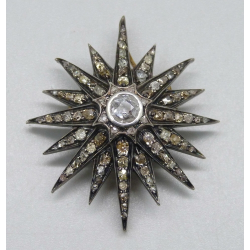 921 - A circa 1900 diamond set starburst pendant/brooch, centre stone approximately 0.75 carat diamond wei... 