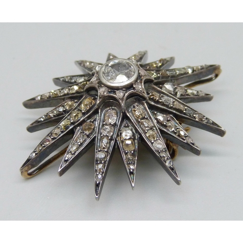 921 - A circa 1900 diamond set starburst pendant/brooch, centre stone approximately 0.75 carat diamond wei... 