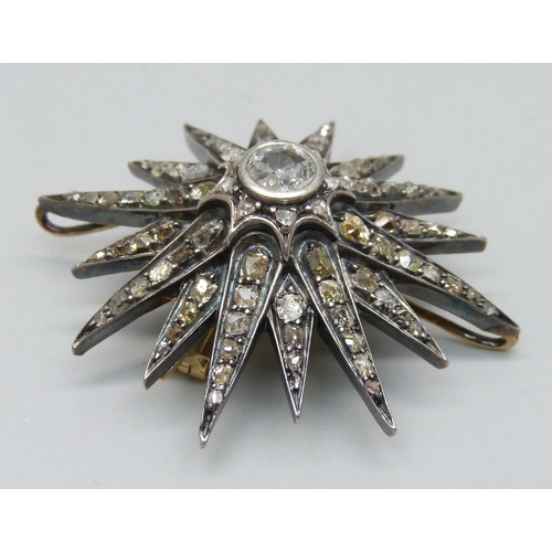 921 - A circa 1900 diamond set starburst pendant/brooch, centre stone approximately 0.75 carat diamond wei... 