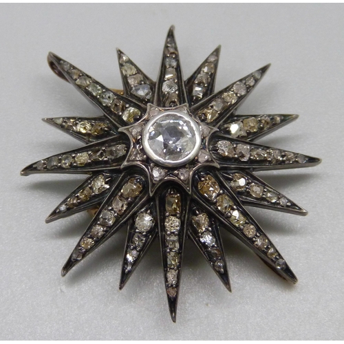 921 - A circa 1900 diamond set starburst pendant/brooch, centre stone approximately 0.75 carat diamond wei... 