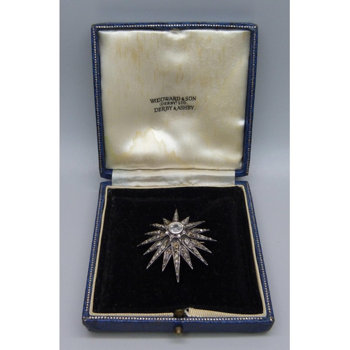 921 - A circa 1900 diamond set starburst pendant/brooch, centre stone approximately 0.75 carat diamond wei... 