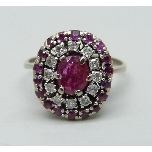 932 - A ruby and diamond cluster ring, marked 950, 4.6g, O