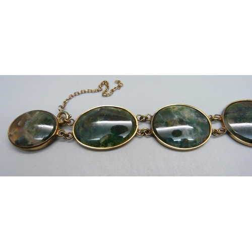 935 - A moss agate and yellow metal set bracelet