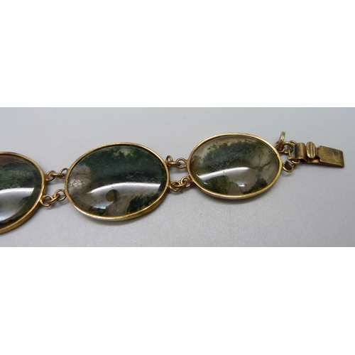 935 - A moss agate and yellow metal set bracelet