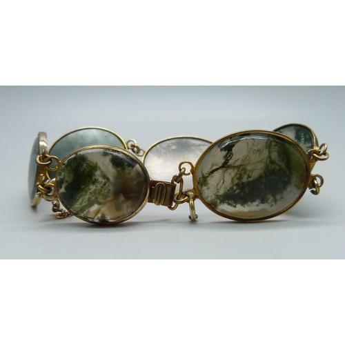 935 - A moss agate and yellow metal set bracelet