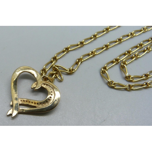 940 - A silver gilt and diamond pendant on a gold plated chain