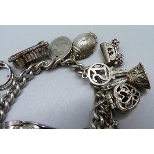 957 - A heavy silver charm bracelet, 90g