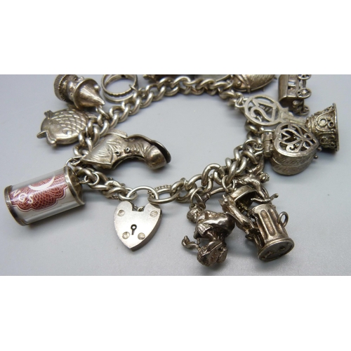 957 - A heavy silver charm bracelet, 90g