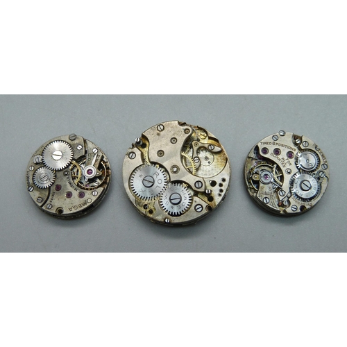 972 - An Omega watch movement, a Rolex watch movement and a Rolex part movement