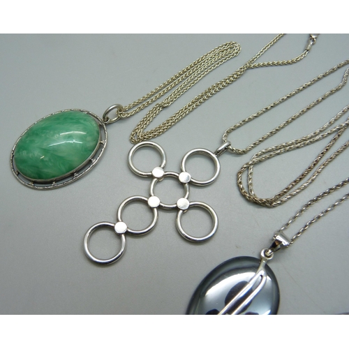 974 - Four silver and silver mounted pendants and chains, all test as silver