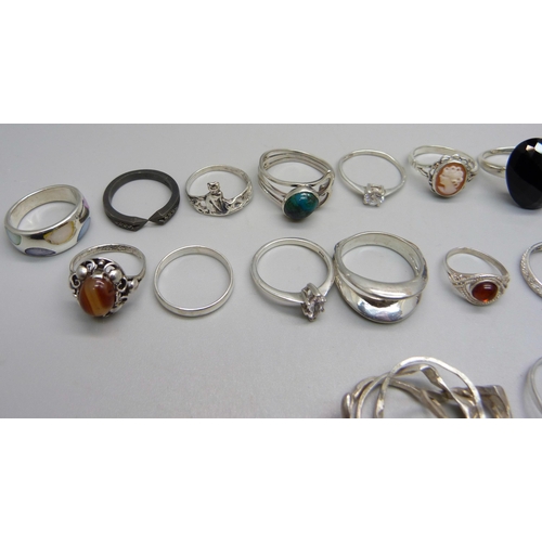 979 - Twenty-three silver rings including one set with black diamonds, (all test as silver), 63g