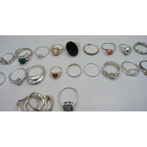 979 - Twenty-three silver rings including one set with black diamonds, (all test as silver), 63g