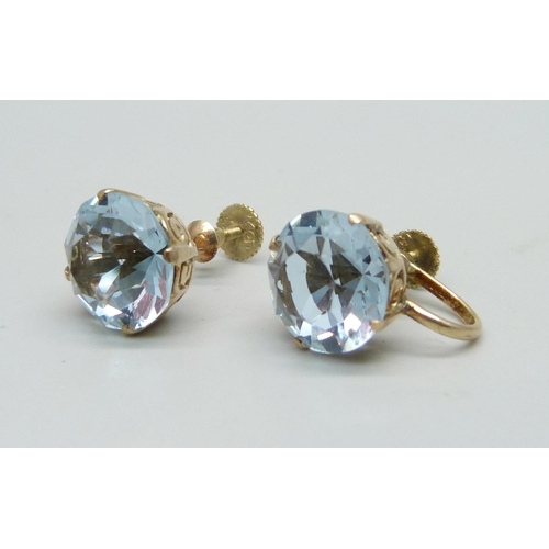 980A - A pair of 14ct gold screw back earrings, set with two lavender coloured stones, 5.12g