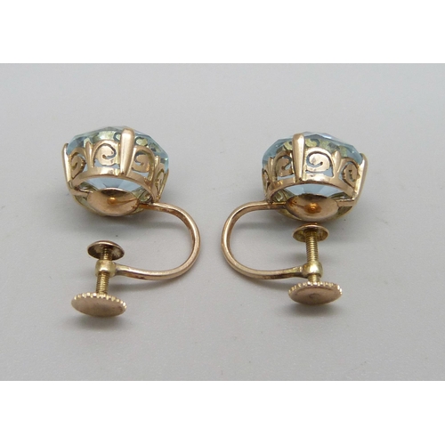 980A - A pair of 14ct gold screw back earrings, set with two lavender coloured stones, 5.12g