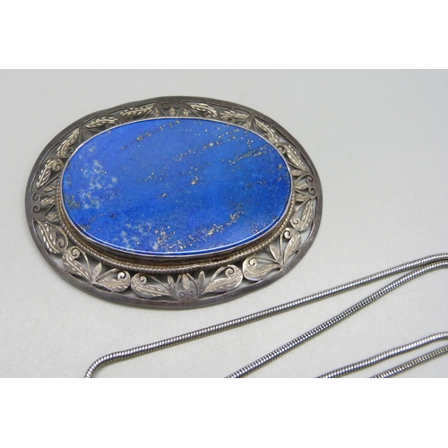 981 - A lapis lazuli and silver jewellery suite; a brooch, pendant and earrings, boxed