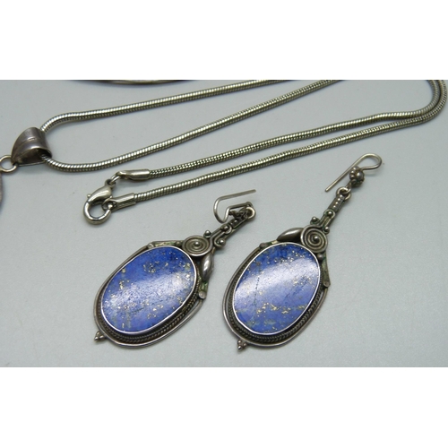 981 - A lapis lazuli and silver jewellery suite; a brooch, pendant and earrings, boxed